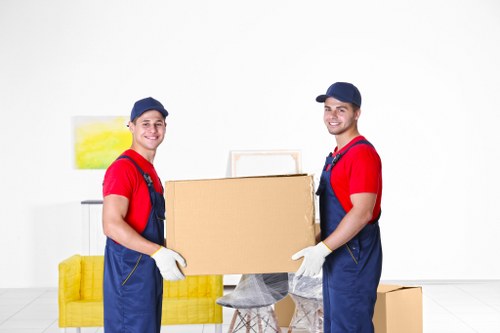 A moving team handling furniture and boxes during student removals in S
