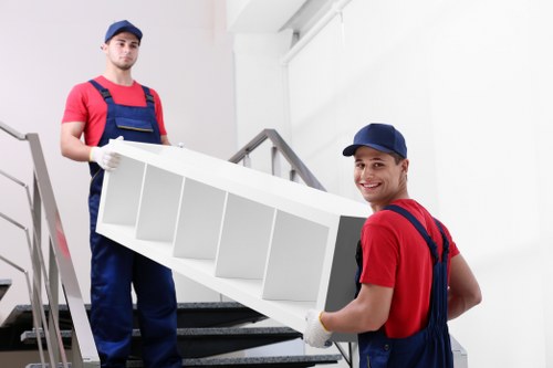 Professional house removalists loading furniture into a moving truck