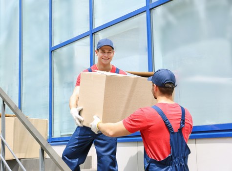 Packed office equipment and labeled moving boxes ready for transport