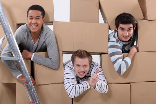Packed moving boxes and furniture ready for removals in S