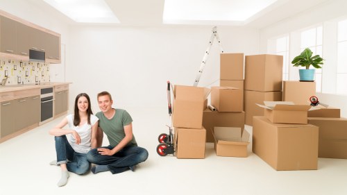 Man with van loading boxes and furniture into a vehicle