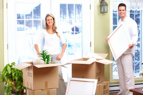 A moving team organizing furniture and boxes inside a home