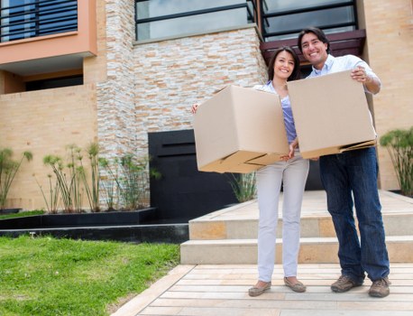 Relocation specialists organizing office furniture during a commercial move